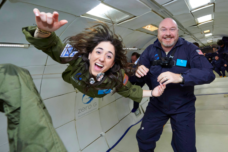 man and woman floating in zero gravity flight